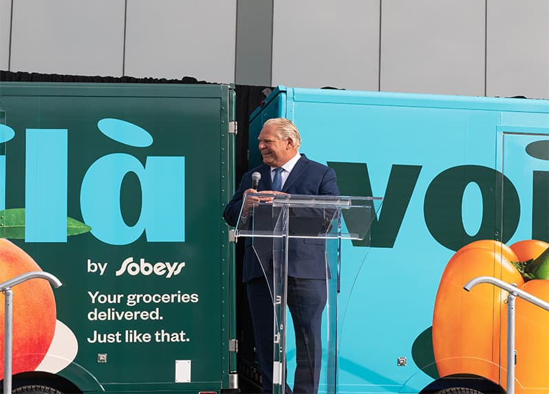 An image displaying Honourable Doug Ford, giving remarks at the Voilà by Sobeys Customer Fulfillment Centre.